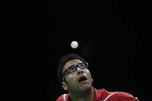 Omar Assar of Egypt eyes the ball as he plays against Lei Kou of Ukraine during their table tennis match at the 2016 Summer Olympics in Rio de Janeiro, Brazil, Sunday, Aug. 7, 2016. (AP Photo/Petros Giannakouris)